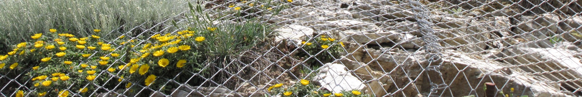 Chain link slope protection net installed over a rocky slope